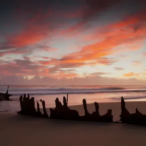 A dramatic sunrise on Dicky Beach with the wreck of the SS Dicky in the foreground