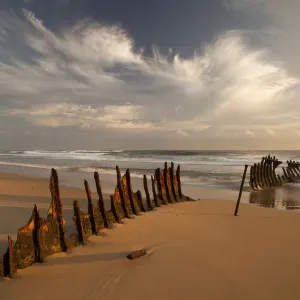 A dramatic sunrise on Dicky Beach with the wreck of the SS Dicky in the foreground