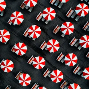 Drone image directly above beach umbrellas, Massa, Italy Drone image directly above beach umbrellas, Massa, Italy