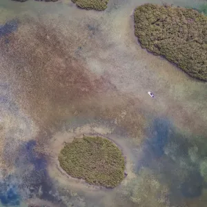 Drone perspective of a small boat in the marshlands, Shark Bay, Australia Drone perspective of a small boat in the marshlands, Shark Bay, Australia