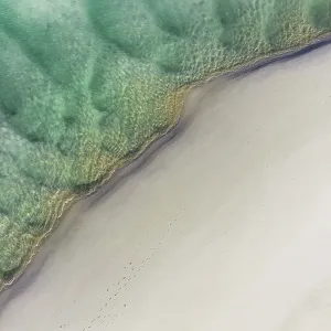 Drone photo showing the edge of a beach on the Noosa River Drone photo showing the edge of a beach on the Noosa River