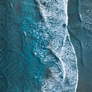 Drone shot showing waves rolling onto a beach, Esperance, Australia
