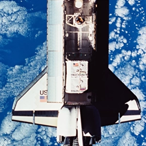 Elevated view of the space shuttle orbiting above the earth with its cargo bay open