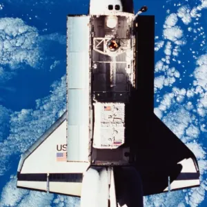 Elevated view of the space shuttle orbiting above the earth with its cargo bay open Elevated view of the space shuttle orbiting above the earth with its cargo bay open
