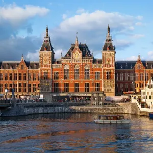 Evening Light Shining on the Station Amsterdam Centraal, Amsterdam, Netherlands Evening Light Shining on the Station Amsterdam Centraal, Amsterdam, Netherlands