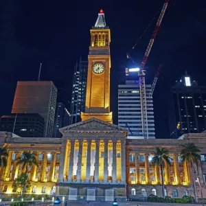 Facade of Brisbanes City hall illuminated at night