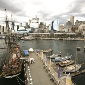 famous old boat sits in harbor or modern city famous old boat sits in harbor or modern city
