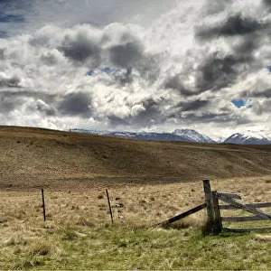 Farm fence panorama as a storm approaches