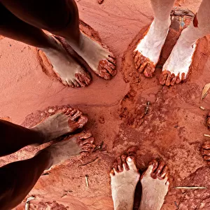 Feet in red sand on beach in Broome, WA