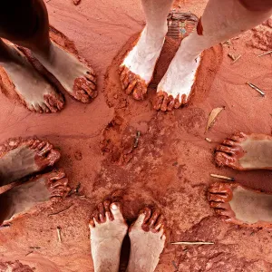 Feet in red sand on beach in Broome, WA Feet in red sand on beach in Broome, WA