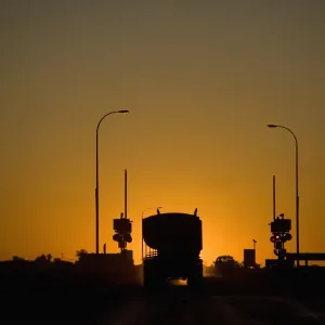 Print of a Freight Truck and Car at Sunset