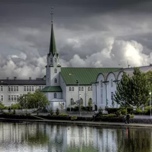 Frikirkjan church Tjornin lake cloudy reflections
