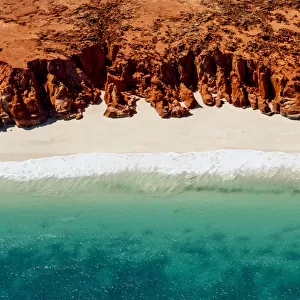 A helicopter view of the white sands, turquoise ocean and striking red Kooljaman Cliffs at Cape Leveque in Western Australias north west