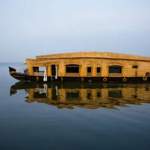 Houseboat Crusing By on Vembanadu Lake in the Misty Morning, Kumarakom, Kottayam, Kerala Backwaters, India Houseboat Crusing By on Vembanadu Lake in the Misty Morning, Kumarakom, Kottayam, Kerala Backwaters, India