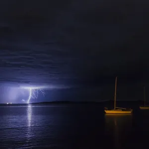 Lightning over moored yacht