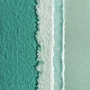 Majestic drone image looking down on rows of Ocean waves rolling onto an idyllic beach, Lucky Bay, Esperance, Western Australia, Australia