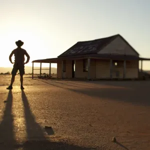 man in front of outback shed