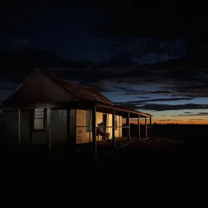 man in front of outback shed