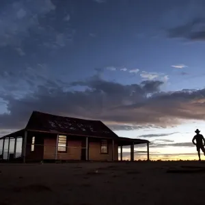 man in front of outback shed