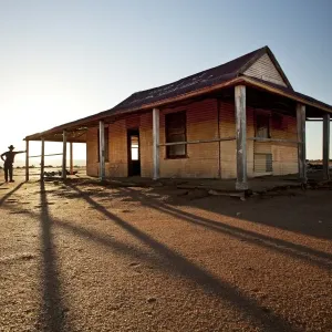 man in front of outback shed