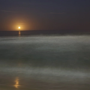 Moon rising over sea (defocussed)