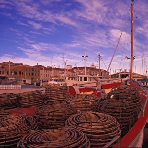 Moored fishing boat with crab traps on foredeck