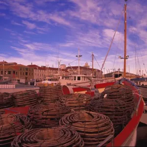 Moored fishing boat with crab traps on foredeck Moored fishing boat with crab traps on foredeck