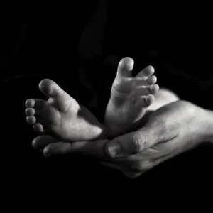 New born feet and mothers hands New born feet and mothers hands