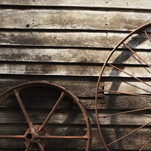 Old Wheels Against A Wooden Wall