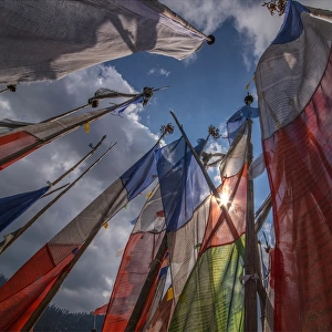 Prayer flags fluttering in the breeze on a mountain pass in central Bhutan