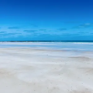 Pristine white sand of Cable Beach edged by the stunning turquoise water
