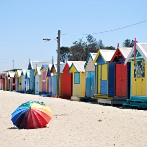 Rainbow umbrella and beach huts