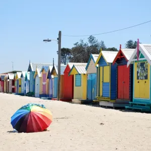 Rainbow umbrella and beach huts