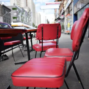 Retro red vinyl chairs on inner-city street Retro red vinyl chairs on inner-city street