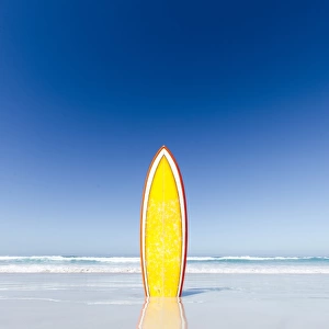 Retro yellow surf board and blue sky. Australia