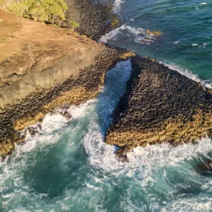 rocky outcrop into ocean at sunrise