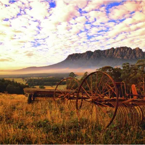 Rusting old agricultural machinery sitting in a filed near Mount Roland, Central Tasmania