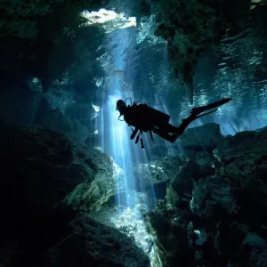 Scuba diver inside cenote in Mexico Scuba diver inside cenote in Mexico