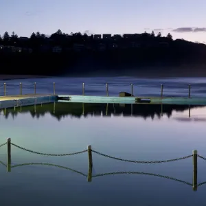 Sea Pool with chain fence reflecting in the still sea water Bilgola New South Wales Australia