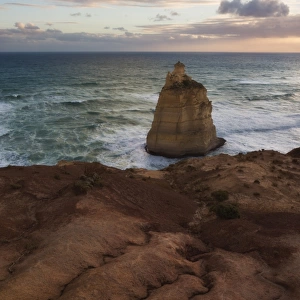 A sea stack below an eroding cliff edge at sunset, Great Ocean Road, Victoria, Australia