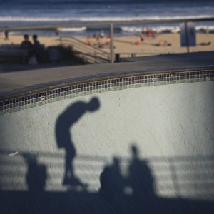 Shadow of skater with beach in background