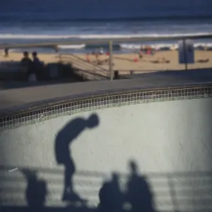Shadow of skater with beach in background Shadow of skater with beach in background