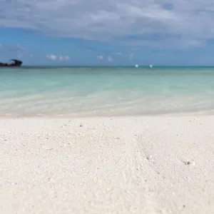 Ship wreck sit on the horizon in the distance as viewed from island beach