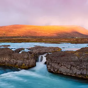 Small Icelandic waterfall at sunrise
