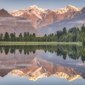 Snowy mountain peaks of Mount Cook and Mount Tasman reflected in Lake Matheson in Snowy mountain peaks of Mount Cook and Mount Tasman reflected in Lake Matheson in