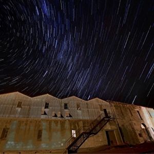 Star-trails appearing over an old warehouse, Oamaru, South Island, New Zealand