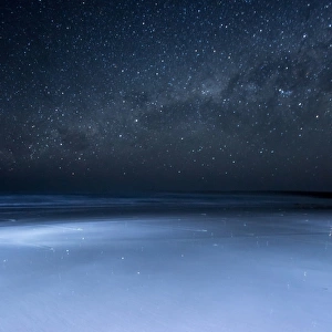 Starfish on a beach and the Milky Way. Australia