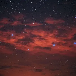 Starry night sky with red clouds Starry night sky with red clouds