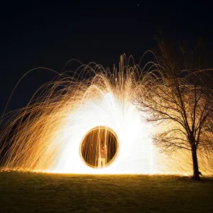 Steel wool spinning near tree at night Steel wool spinning near tree at night