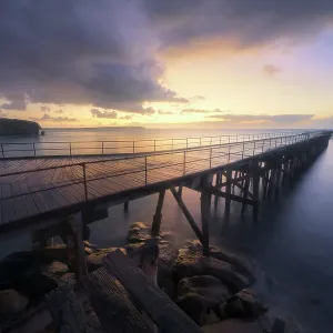 Stenhouse Bay jetty with sea, cliffs, pier and rocks at dawn on the Yorke Peninsula, South Australia Stenhouse Bay jetty with sea, cliffs, pier and rocks at dawn on the Yorke Peninsula, South Australia